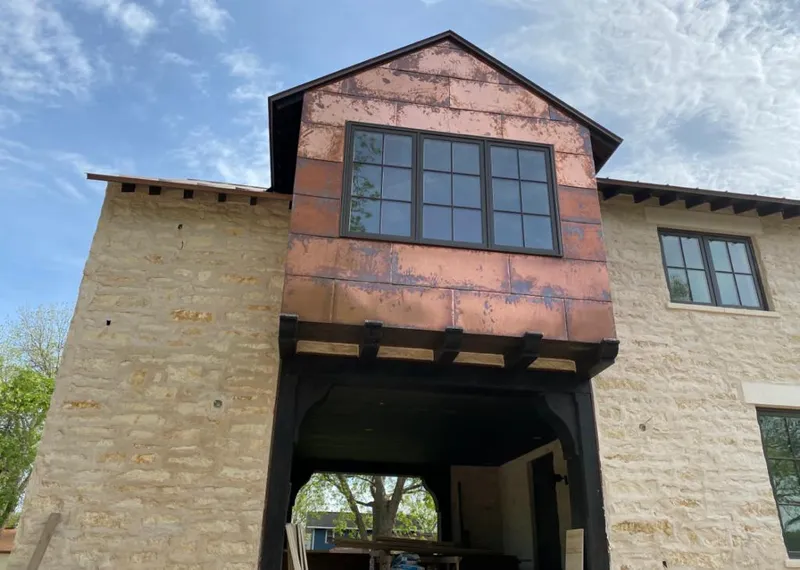 Copper metal panel facade on a stone building for Roof Repair in Miami Gardens