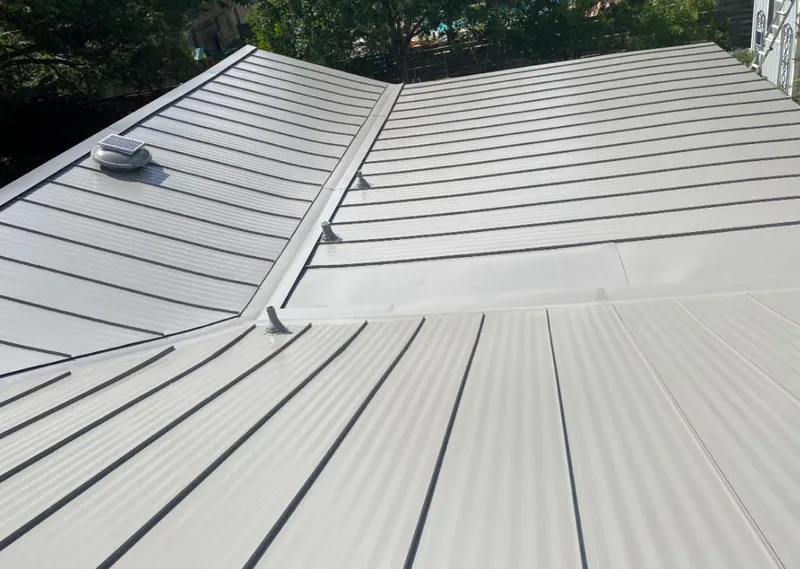 Solar attic fan installed on a metal roof for Roof Ventilation in Miami Gardens